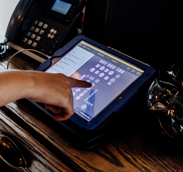 Das Bild zeigt das OpenTable-Reservierungssystem, das auf einem Tablet verwendet wird, um Restauranttische zu überprüfen